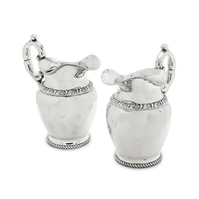 A pair of 19th century silver jugs / pitchers probably Indian Colonial, maker's mark C&C in a rectangular punch with serrated edge, English style lion passant mark and leopards head mark, and '8', also stamped with French import mark and Italian mark for Rome (2)